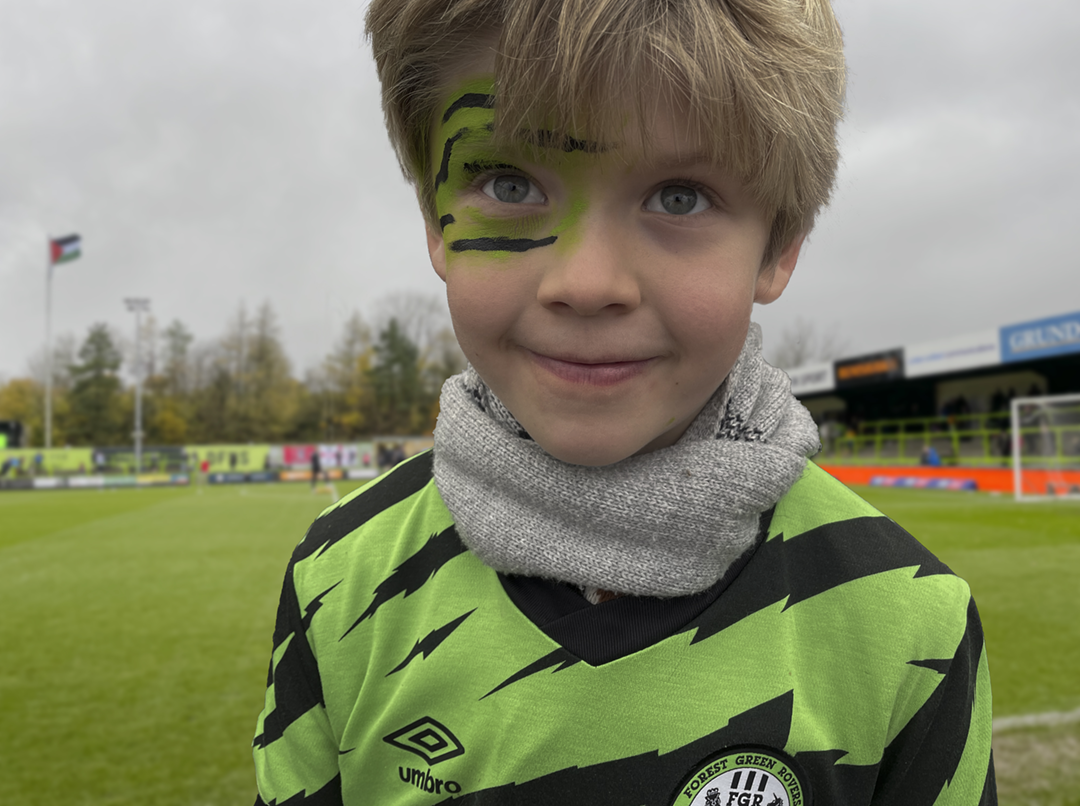 YoungBoy football supporter in green shirt